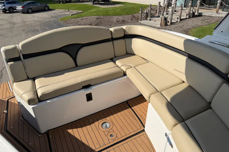 Slide: The Image of 2019 Rinker EX 320 boat interior with beige seating and teak flooring. - 5