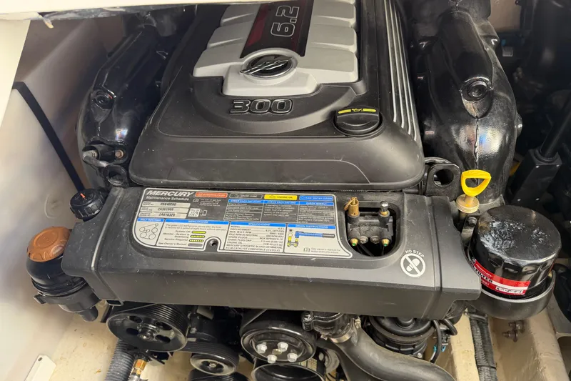 Slide: The Image of Engine compartment of a 2019 Rinker EX 320 boat with Mercury 6.2L engine. - 59