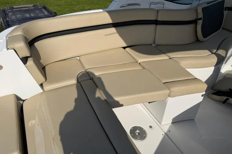 Slide: The Image of 2019 Rinker EX 320 boat with beige leather seating in sunlight. - 6