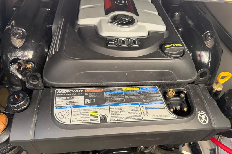 Slide: The Image of Close-up of a 2019 Rinker EX 320 boat engine, featuring Mercury maintenance schedule. - 60