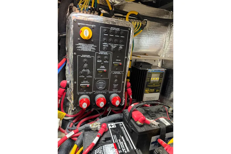 Slide: The Image of Electrical panel and battery setup in a 2019 Rinker EX 320 boat. - 62