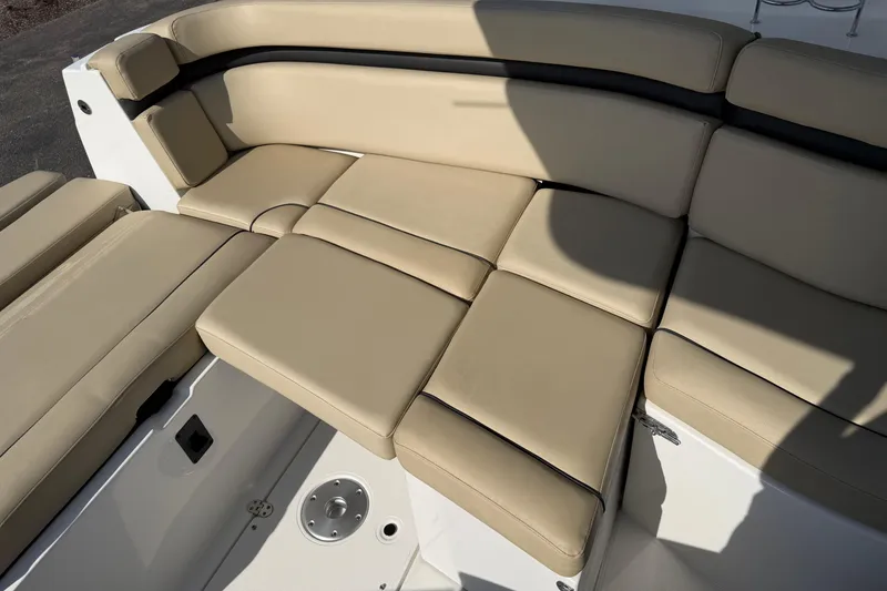 Slide: The Image of 2019 Rinker EX 320 boat with beige cushioned seating area. - 7