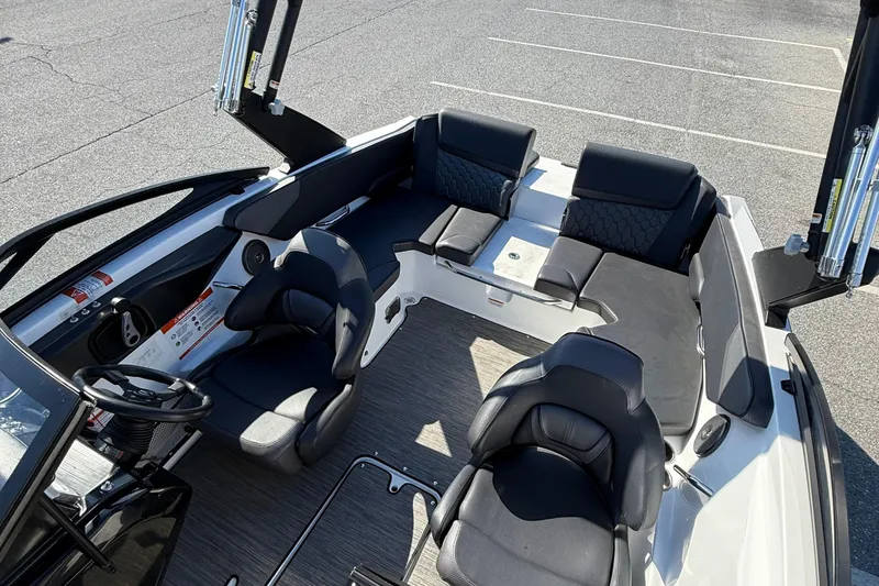 Slide: The Image of 2024 Scarab 195 ID boat interior with black seating and modern design. - 10