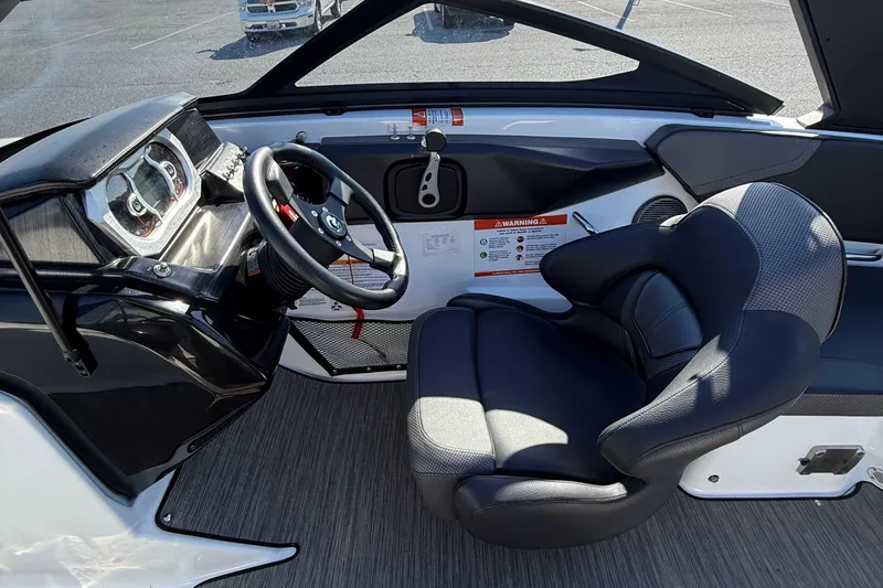 Slide: The Image of 2024 Scarab 195 ID boat interior with steering wheel and cushioned seat. - 12