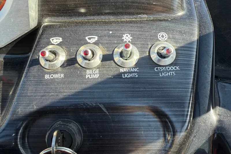 Slide: The Image of Control panel of 2024 Scarab 195 ID boat with switches for blower, bilge pump, and lights. - 14