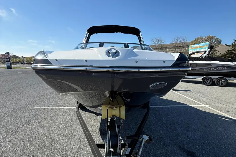 Slide: The Image of 2024 Scarab 195 ID boat on trailer, front view in parking lot. - 3