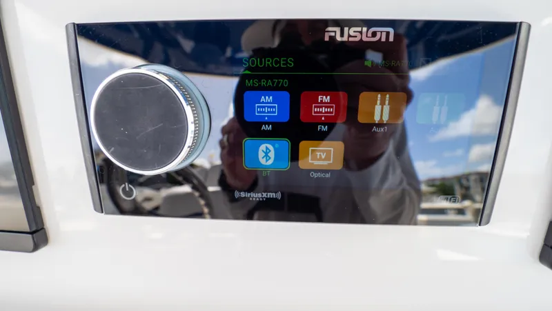Slide: The Image of Touchscreen audio system on 2022 Intrepid 345 Valor boat, displaying various media sources. - 22