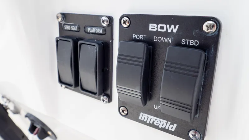 Slide: The Image of Control panel of 2022 Intrepid 345 Valor boat with labeled switches. - 25