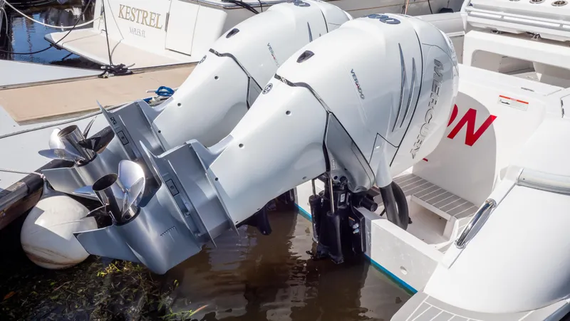 Slide: The Image of Twin outboard engines on a 2022 Intrepid 345 Valor boat docked in water. - 38