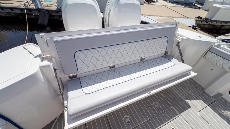 Slide: The Image of 2022 Intrepid 345 Valor boat with foldable rear seating and dual outboard engines. - 4