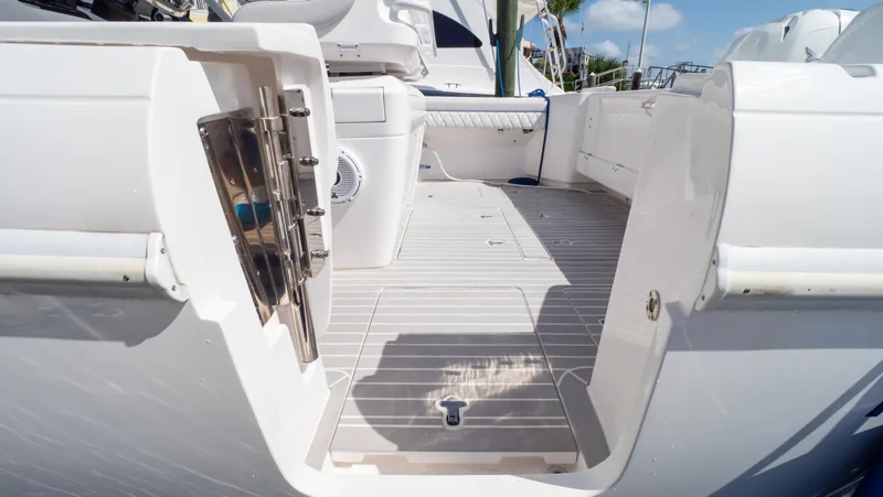 Slide: The Image of 2022 Intrepid 345 Valor boat deck with open side door, showcasing spacious interior. - 40