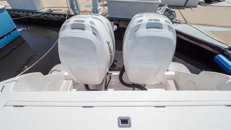 Slide: The Image of Twin outboard engines on a 2022 Intrepid 345 Valor boat at a dock. - 44