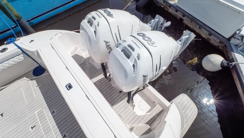 Slide: The Image of 2022 Intrepid 345 Valor boat with twin outboard engines docked at marina. - 46