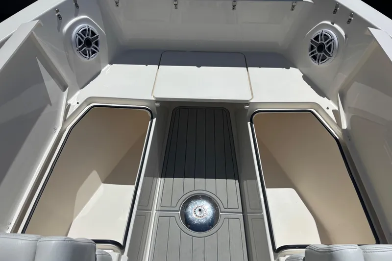 Slide: The Image of 2023 Cobia 280 Dual Console boat interior with storage compartments and speakers. - 11
