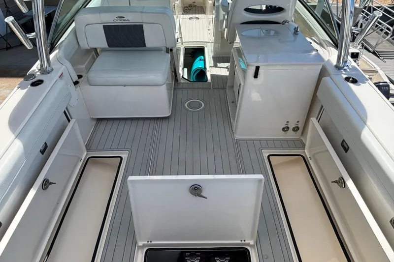 Slide: The Image of 2023 Cobia 280 Dual Console boat interior with seating and storage compartments. - 13