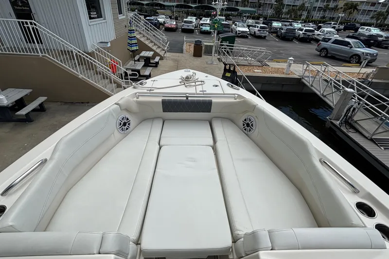 Slide: The Image of 2023 Cobia 280 Dual Console boat with spacious seating at dockside. - 8