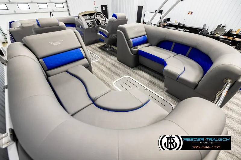 Slide: The Image of Luxurious interior of a 2025 Bennington LTFBSE pontoon boat with gray and blue seating. - 11