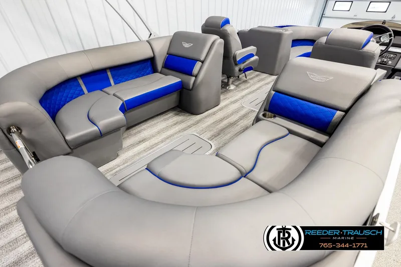 Slide: The Image of 2025 Bennington LTFBSE pontoon boat interior with gray and blue seating, luxurious design. - 12
