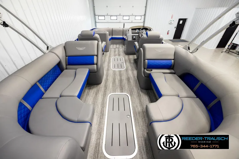 Slide: The Image of 2025 Bennington LTFBSE pontoon boat interior with gray and blue seating, spacious layout. - 16