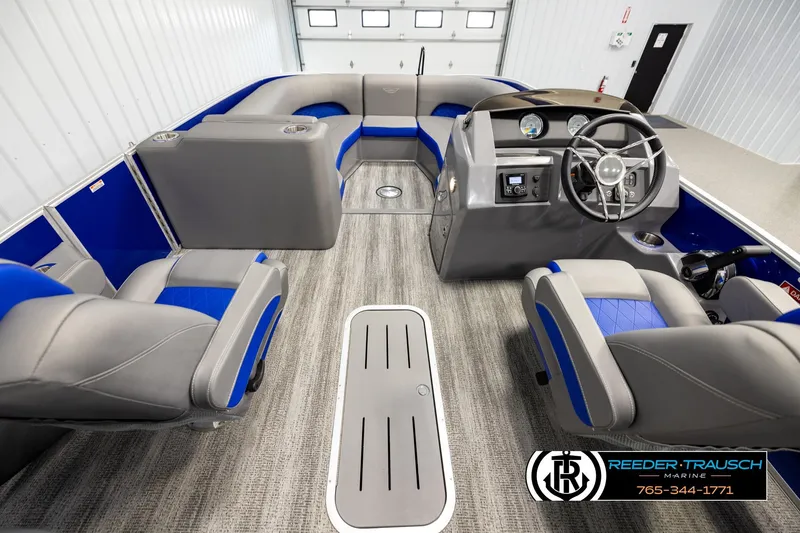 Slide: The Image of Interior of a 2025 Bennington LTFBSE pontoon boat with blue and gray seating. - 17