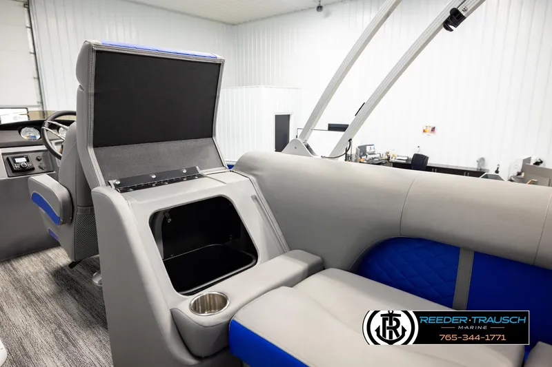 Slide: The Image of 2025 Bennington LTFBSE boat interior with storage compartment and cup holder. - 26