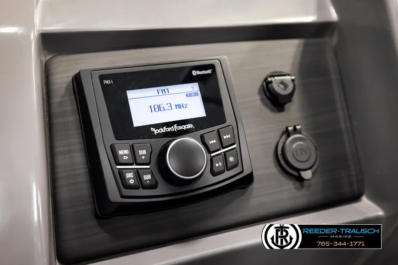 Slide: The Image of 2025 Bennington LTFBSE boat dashboard with Rockford Fosgate stereo and 12V outlets. - 32