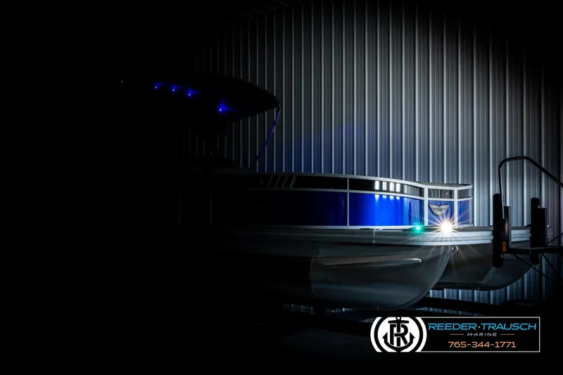 Slide: The Image of 2025 Bennington LTFBSE pontoon boat with blue LED lights in a dimly lit setting. - 4