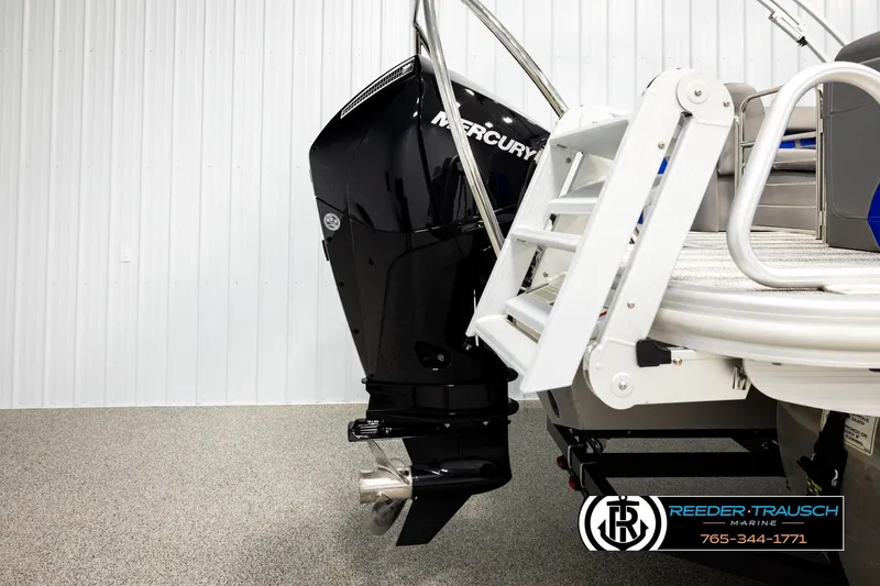 Slide: The Image of 2025 Bennington LTFBSE boat with Mercury outboard motor and swim ladder in showroom. - 46