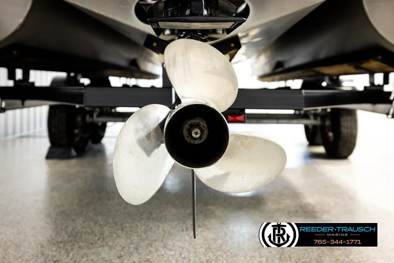 Slide: The Image of Propeller of a 2025 Bennington LTFBSE boat on a trailer in a showroom. - 49
