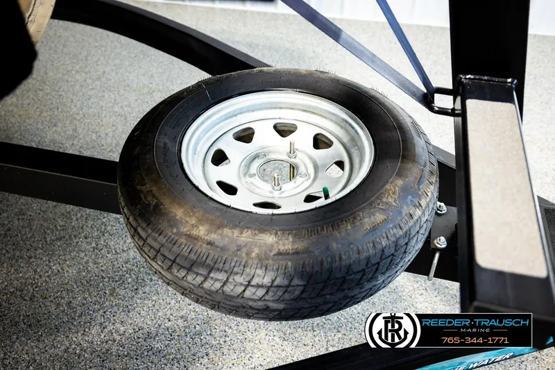 Slide: The Image of 2025 Bennington LTFBSE trailer tire on display at Reeder-Trausch Marine showroom. - 50