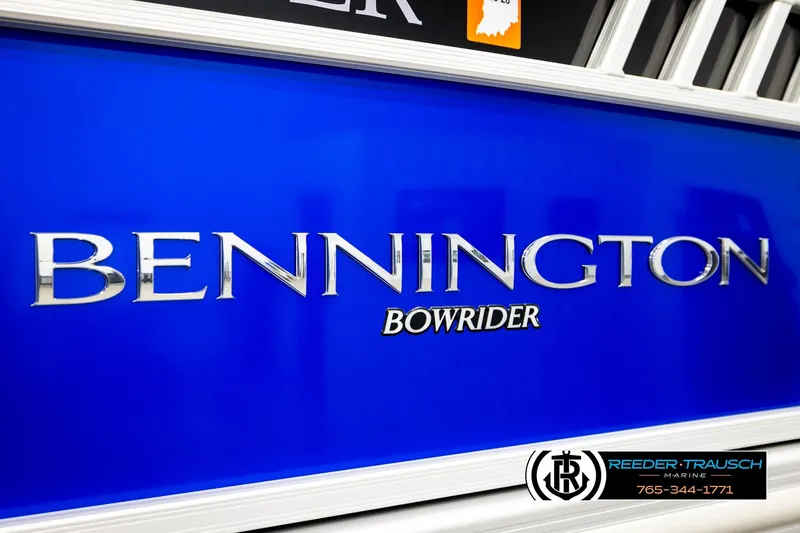 Slide: The Image of 2025 Bennington LTFBSE Bowrider boat with blue exterior and dealership logo. - 53