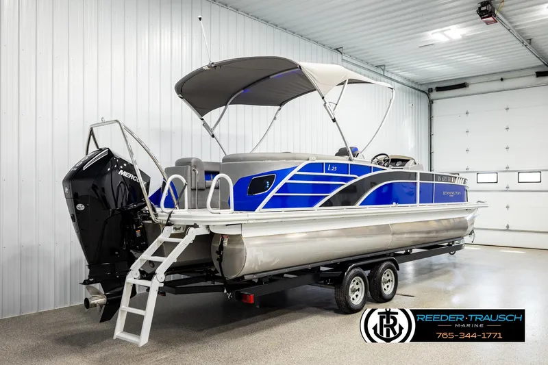 Slide: The Image of 2025 Bennington LTFBSE pontoon boat with canopy, displayed indoors on a trailer. - 6
