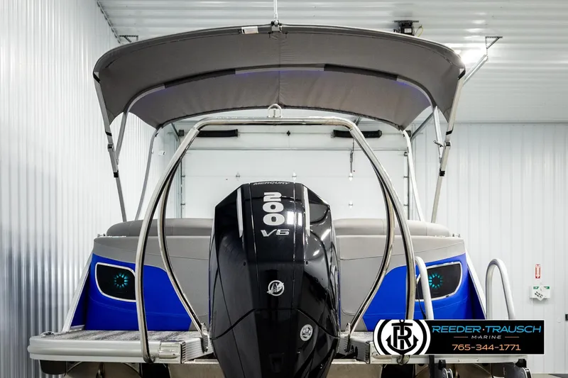 Slide: The Image of 2025 Bennington LTFBSE boat with 200 HP Mercury engine in storage facility. - 7