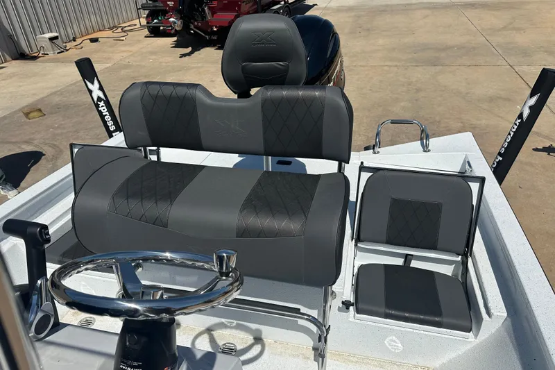 Slide: The Image of Open storage compartment on 2026 Xpress H20B Bay boat. - 10