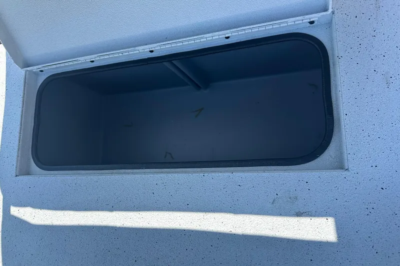 Slide: The Image of Open compartment on 2026 Xpress H20B Bay boat with metal handles. - 11