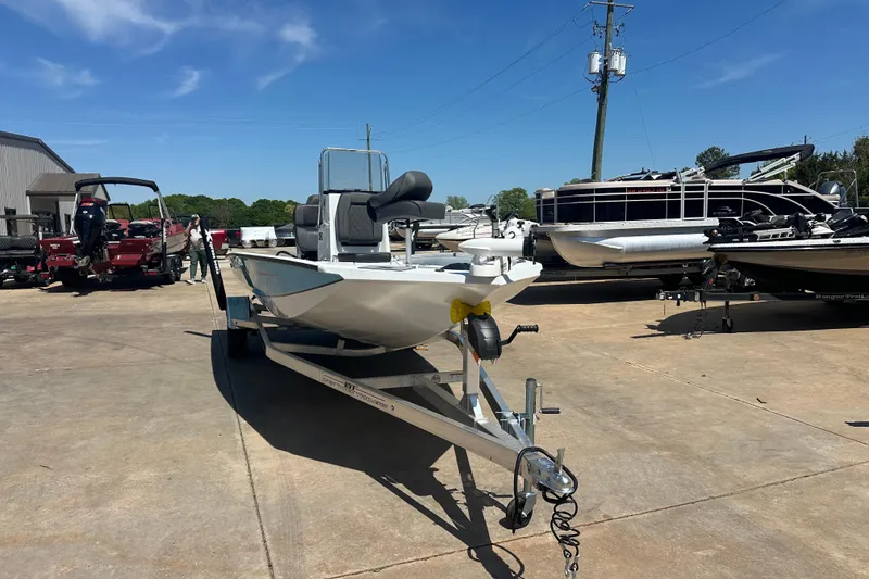 Slide: The Image of 2026 Xpress H20B Bay boat on trailer outside service building. - 3