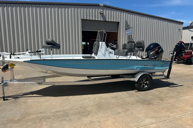 Slide: The Image of Trolling motor on 2026 Xpress H20B Bay boat, outdoors with trees in background. - 5