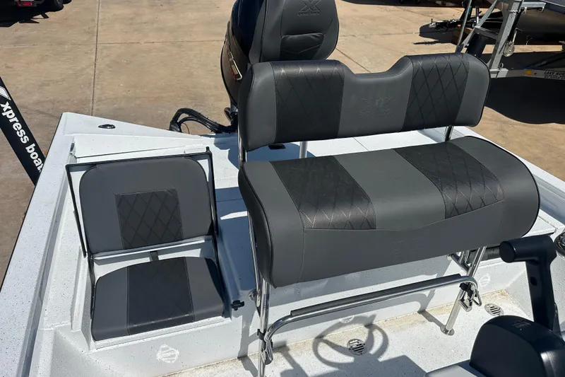 Slide: The Image of 2026 Xpress H20B Bay boat interior with steering wheel and cushioned seating. - 9