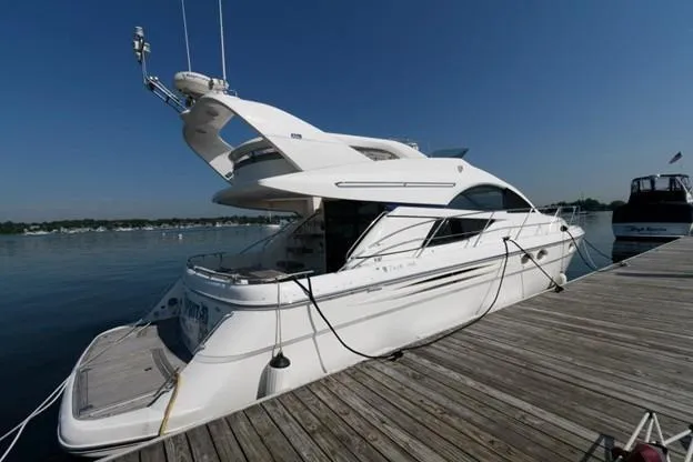 Slide: The Image of 2007 Fairline Phantom 46 yacht docked at a marina under clear blue skies. - 15