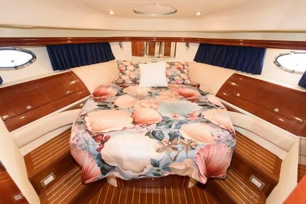 Slide: The Image of Luxurious 2007 Fairline Phantom 46 yacht bedroom with floral bedding and elegant wood finishes. - 18