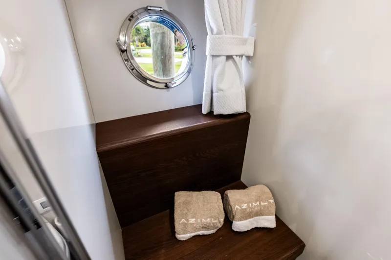 Slide: The Image of Interior of 2017 Azimut Fly 72 yacht with porthole and branded towels. - 42