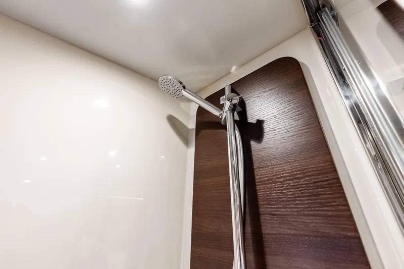 Slide: The Image of Shower area in 2017 Azimut Fly 72 yacht with modern fixtures and wood paneling. - 48