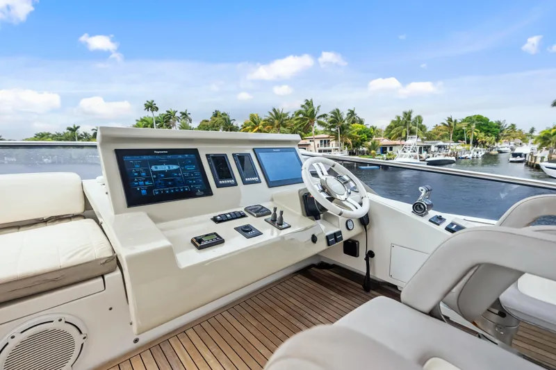 Slide: The Image of Luxurious 2017 Azimut Fly 72 yacht helm with modern controls and scenic waterfront view. - 58
