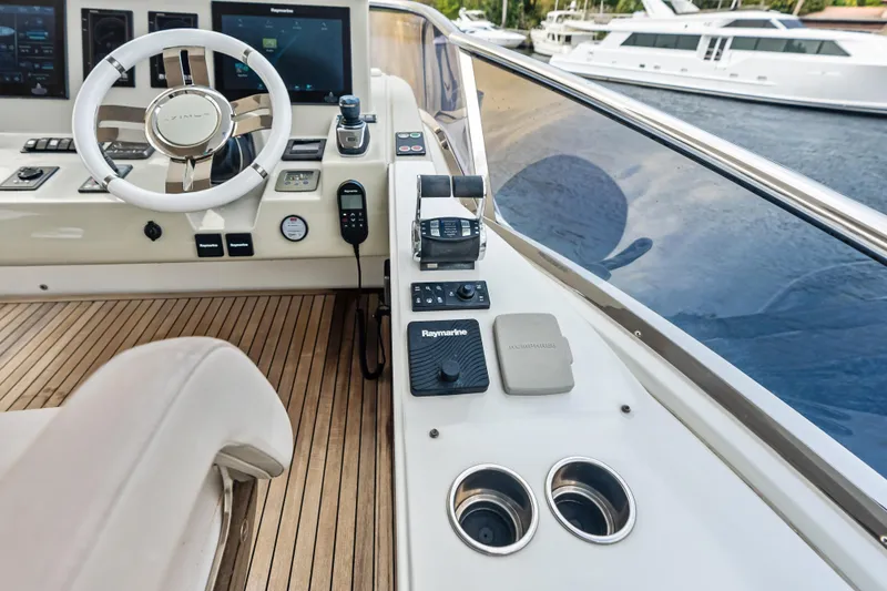 Slide: The Image of Cockpit of 2017 Azimut Fly 72 yacht with steering wheel and navigation controls. - 59