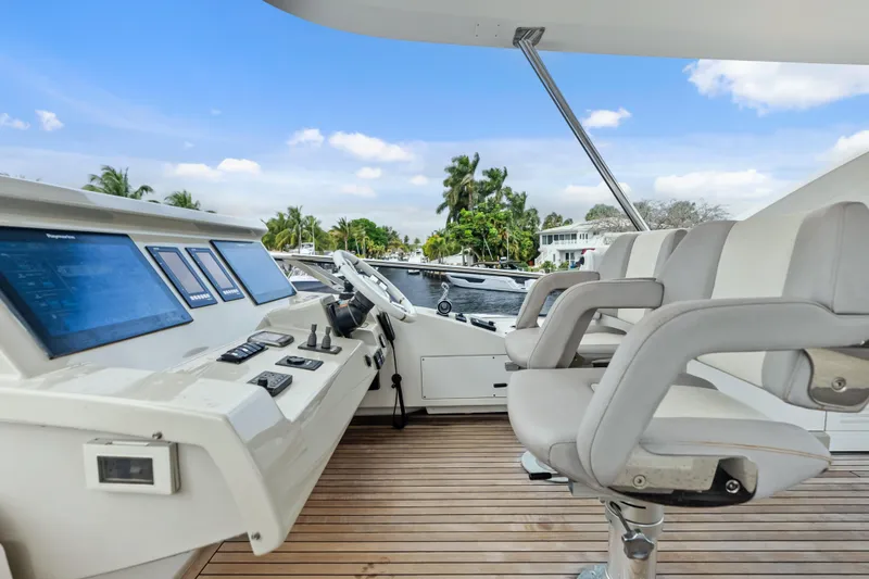 Slide: The Image of Luxurious 2017 Azimut Fly 72 yacht helm with modern controls and plush seating. - 61