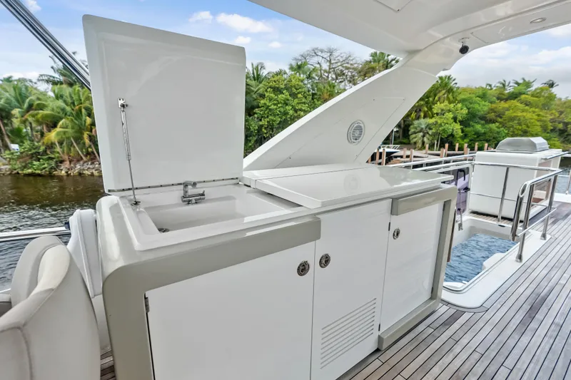 Slide: The Image of Outdoor kitchen on 2017 Azimut Fly 72 yacht with sink and storage, surrounded by lush greenery. - 69