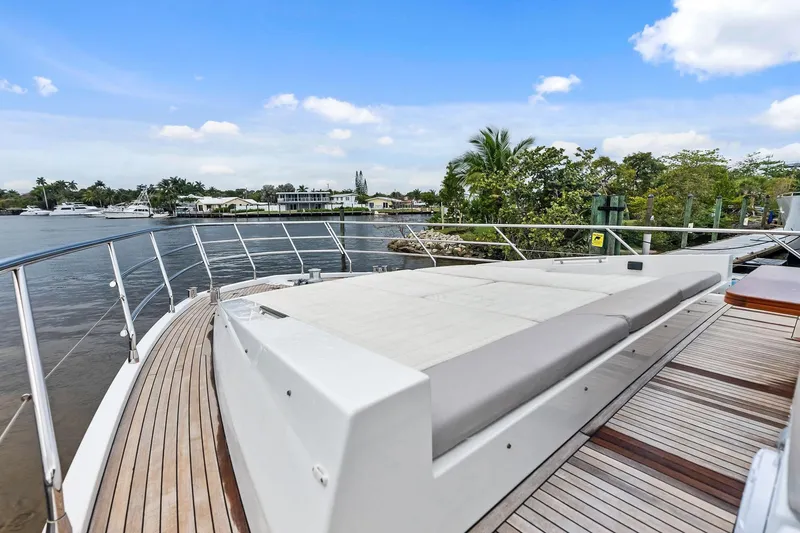 Slide: The Image of Luxurious 2017 Azimut Fly 72 yacht deck with sunbed, overlooking serene waterfront scenery. - 7