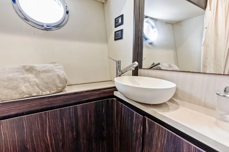Slide: The Image of Luxurious bathroom interior of 2017 Azimut Fly 72 yacht with modern sink and porthole. - 78