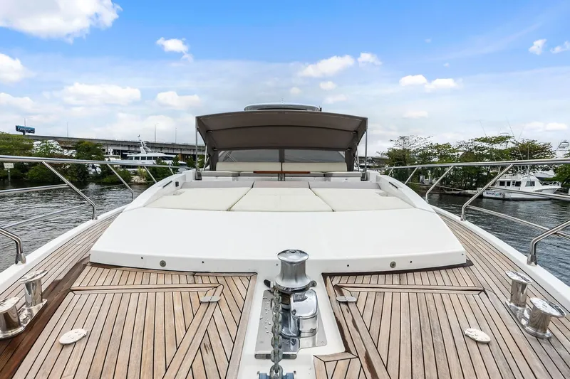 Slide: The Image of Luxurious 2017 Azimut Fly 72 yacht deck with sunbathing area, docked by a serene waterfront. - 8