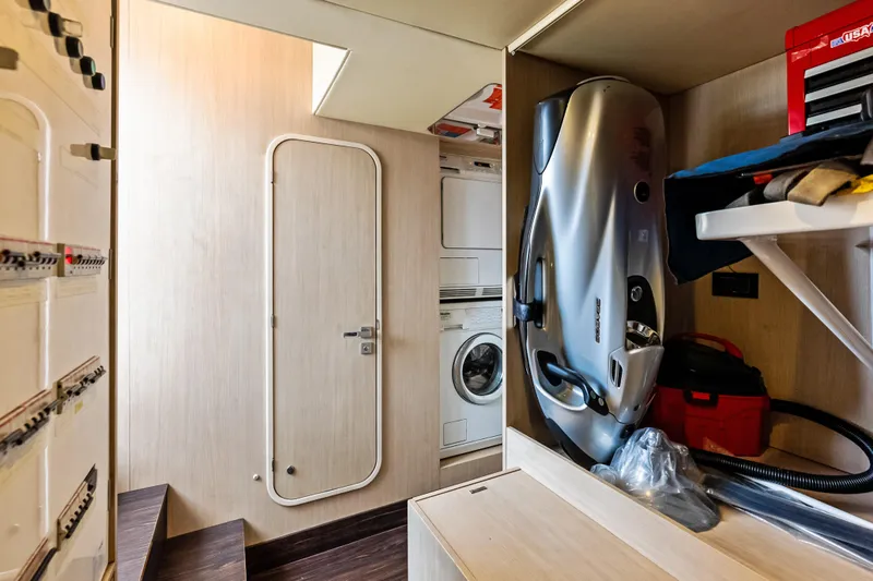 Slide: The Image of Laundry and storage area inside a 2017 Azimut Fly 72 yacht, featuring modern appliances. - 80